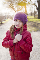 girl holds her hands together and looking to the camera