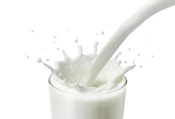 Fotobehang Milkshake pouring milk or white liquid in a glass created splash