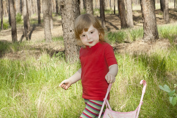 little girl walks in the woods
