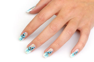 Female hand with manicure close up. Drawing of a branch with blu