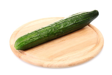 long cucumber on wooden cutting board isolated on white
