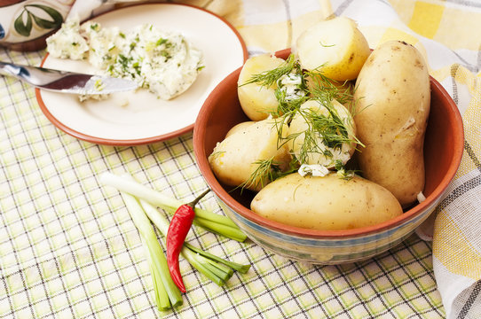 Boiled brown potatoes with green butter