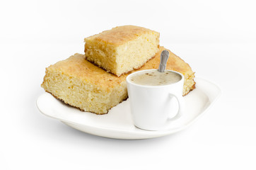 Sponge cake and a cup of coffe on white background