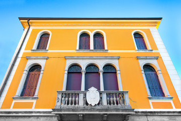 Traditional Italian yellow house against blue sky