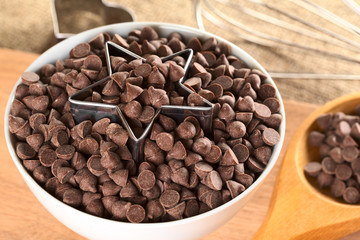 Star-shaped cookie cutter with chocolate chips in a bowl