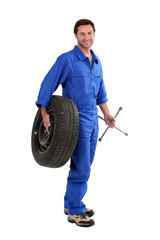 mechanic holding a tire