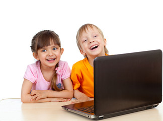 Funny children using a laptop over white background