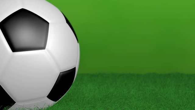 Rotating soccer ball on green background