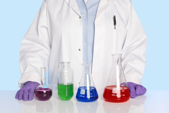 Chemist standing at a desk with chemicals