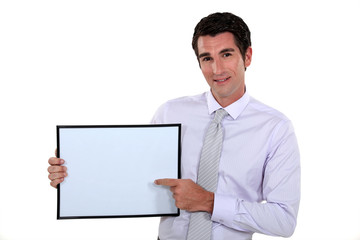 Man pointing at white box