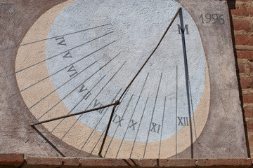 sundial on the wall of an old home