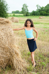 Naklejka na ściany i meble Beautiful long-haired girl in a field