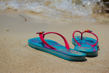 Colored flip-flops on the beach