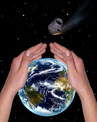 hands covering the planet