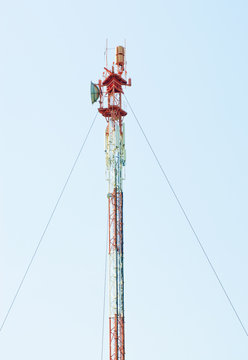 Telecommunications tower with different antenna  on blue sky