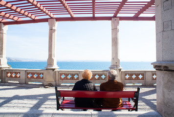 Elders sitting on a bench, Miramare castle - Trieste
