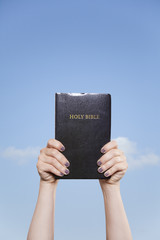 Holding the Bible High in the Sky