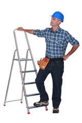 Manual worker stood with ladder