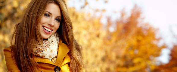 Beautiful elegant womanin autumn park
