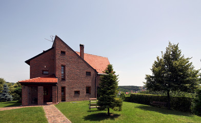 Fototapeta na wymiar modern bricks house, surrounded by nature