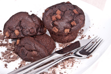 Brown muffins with chocolate on a plate