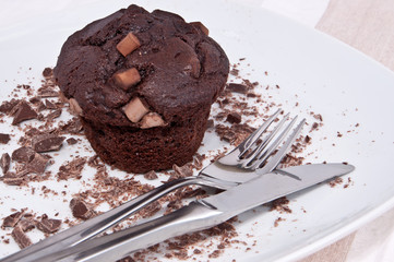 Brown muffins with chocolate and cutlery