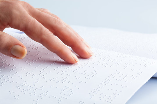 Blindenschrift und Finger. Buch in Braille