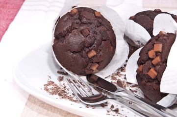 Fresh chocolate muffins on a plate