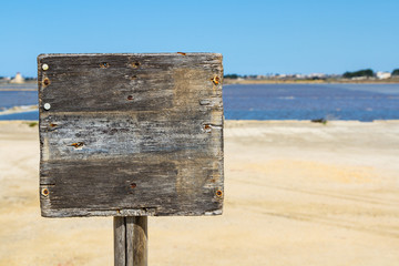 An old grey wooden sign