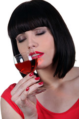 Brunette smelling glass of wine