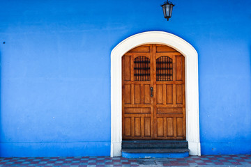 Wooden door and blue wall