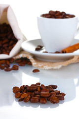 Composition of the cup with coffee beans isolated on white