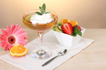 fruit jelly in glass and fruits on table in cafe
