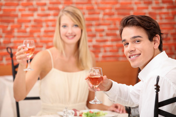 Couple toasting with pink wine