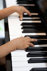 Little hands playing on the piano