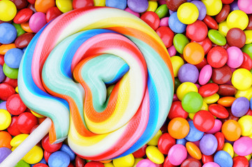 Striped lollipop and multicolored smarties