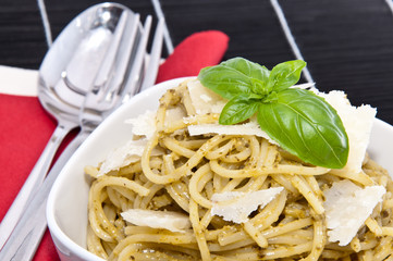Spaghettis in a bowl on a black tablecloth