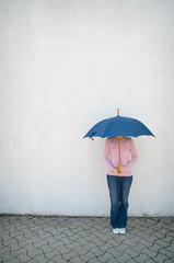 Young woman hidden under umbrella