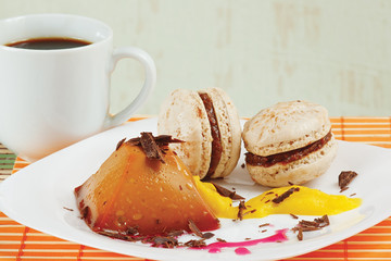 Cup of coffee, macaroons and caramel pudding still life