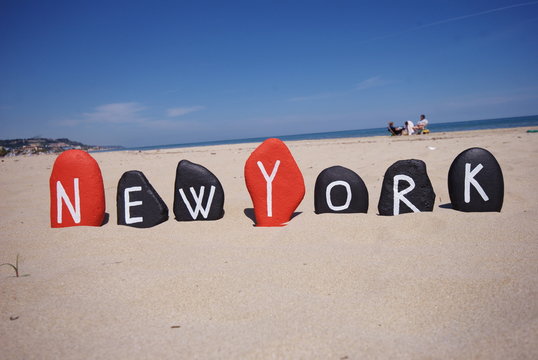 Fototapeta New York, word on stones with sand background