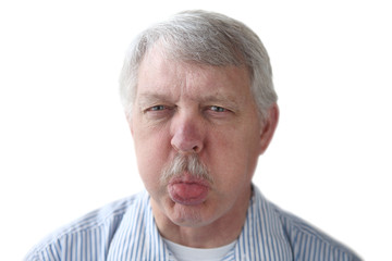 an older man blows a raspberry in a rude gesture