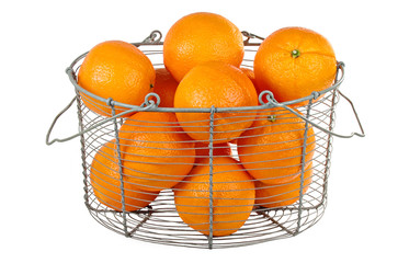 Oranges in a basket isolated on white