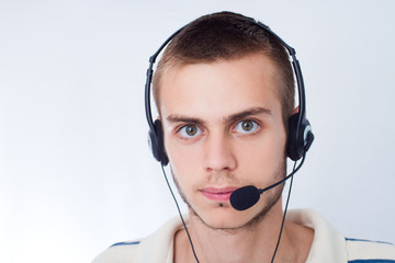 young man talking on headset against a white background