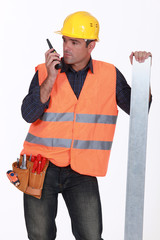 Tradesman speaking into a walkie talkie