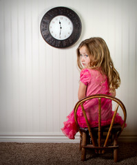 little girl in time out or in trouble looking