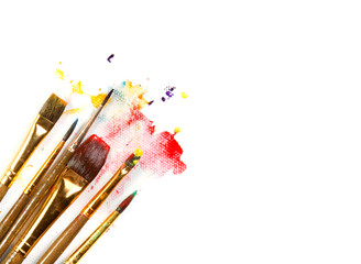 Assorted paint brushes with paint