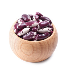 wooden bowl full of speckled beans isolated on white