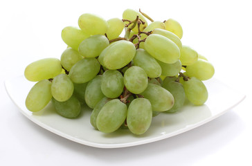 Green grapes on white plate