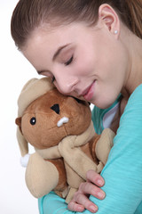 Woman hugging cuddly toy
