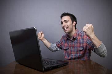 Joyful young man with laptop